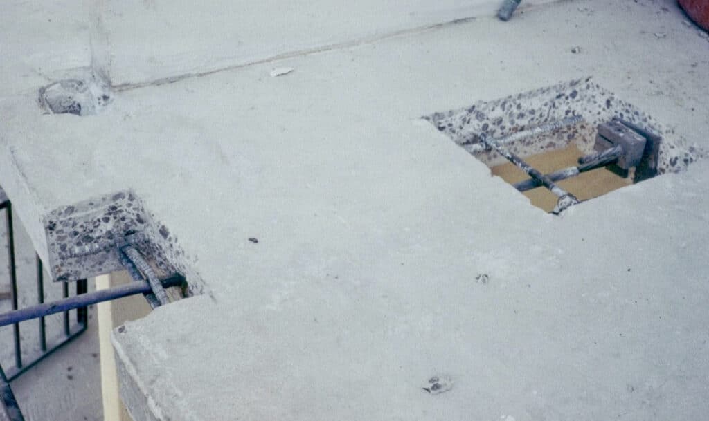 Shown is a fully excavated slab edge per ICRI requirements with tendon lock-off installed