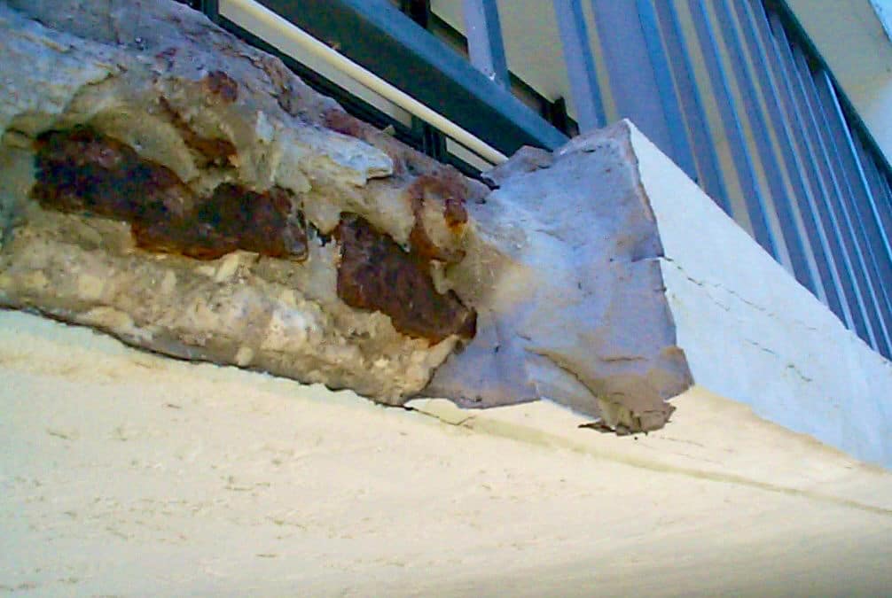 This failed slab edge patch was applied to the surface of the anchors without fully excavating the damaged area
